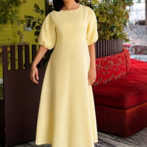 Aurélie Cotton Dress in butter yellow, highlighting the soft cotton texture and flowing midi length