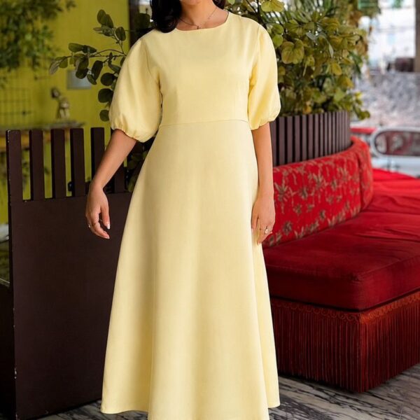 Aurélie Cotton Dress in butter yellow, highlighting the soft cotton texture and flowing midi length